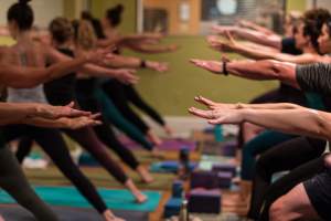 hands reaching out in yoga clas