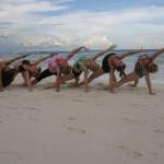 Group yoga on the beach in tulum