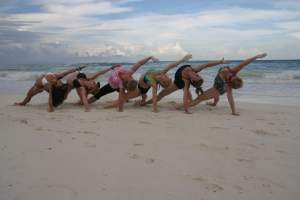 Group yoga on the beach in tulum