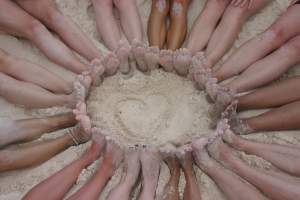 group's feet on the beach in Tulum